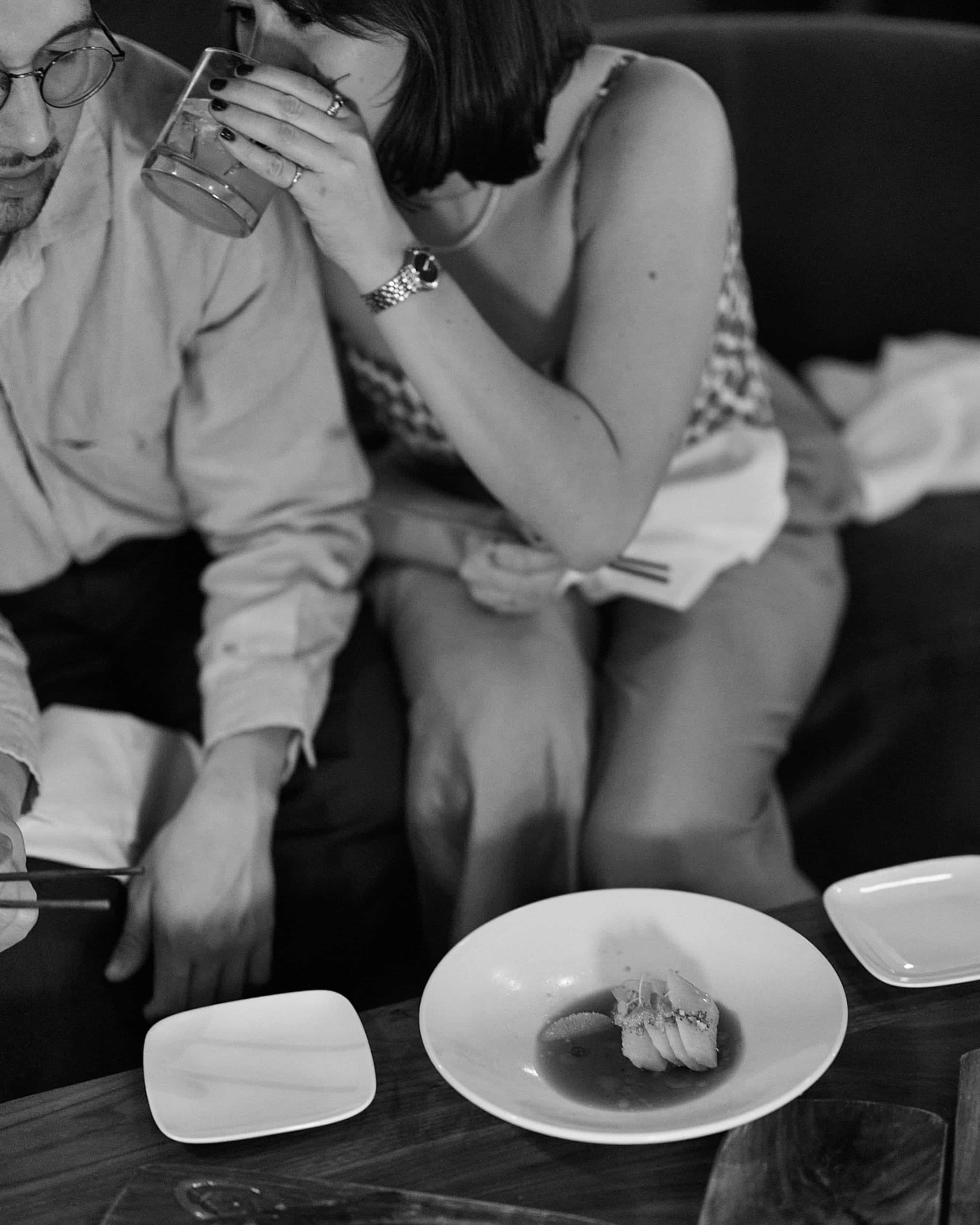 couple enjoying sushi at uchiba in black and white