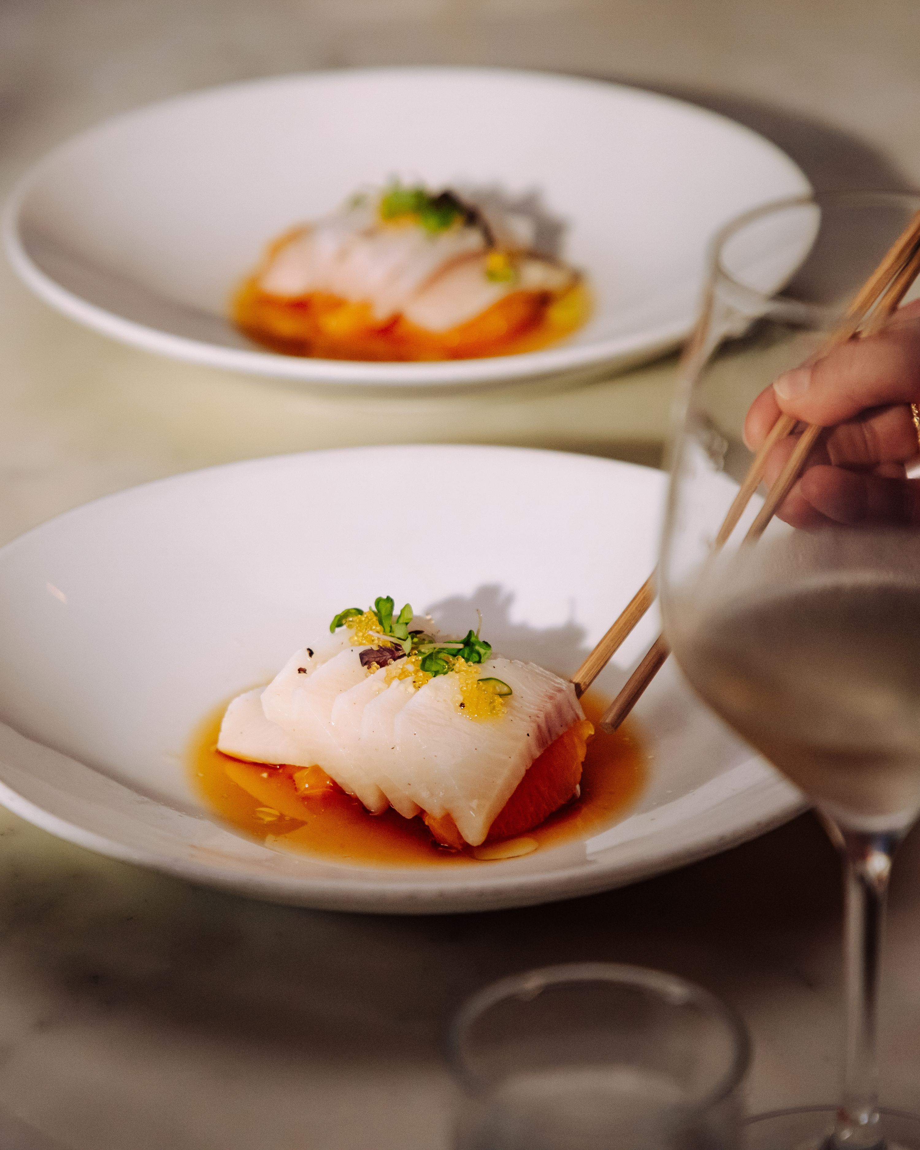 hama chili with a glass of wine at uchiba